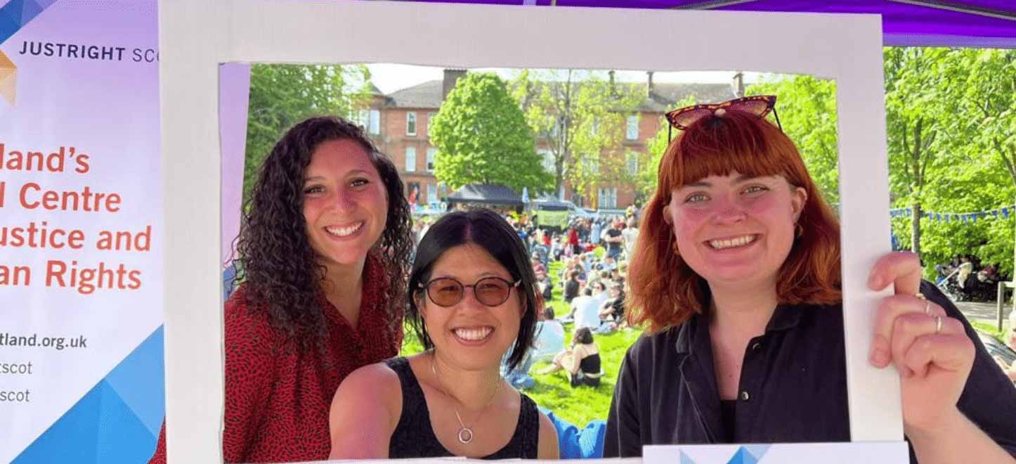 Three women holding up a frame with the words I support human rights, and the Just Right Scotland logo.