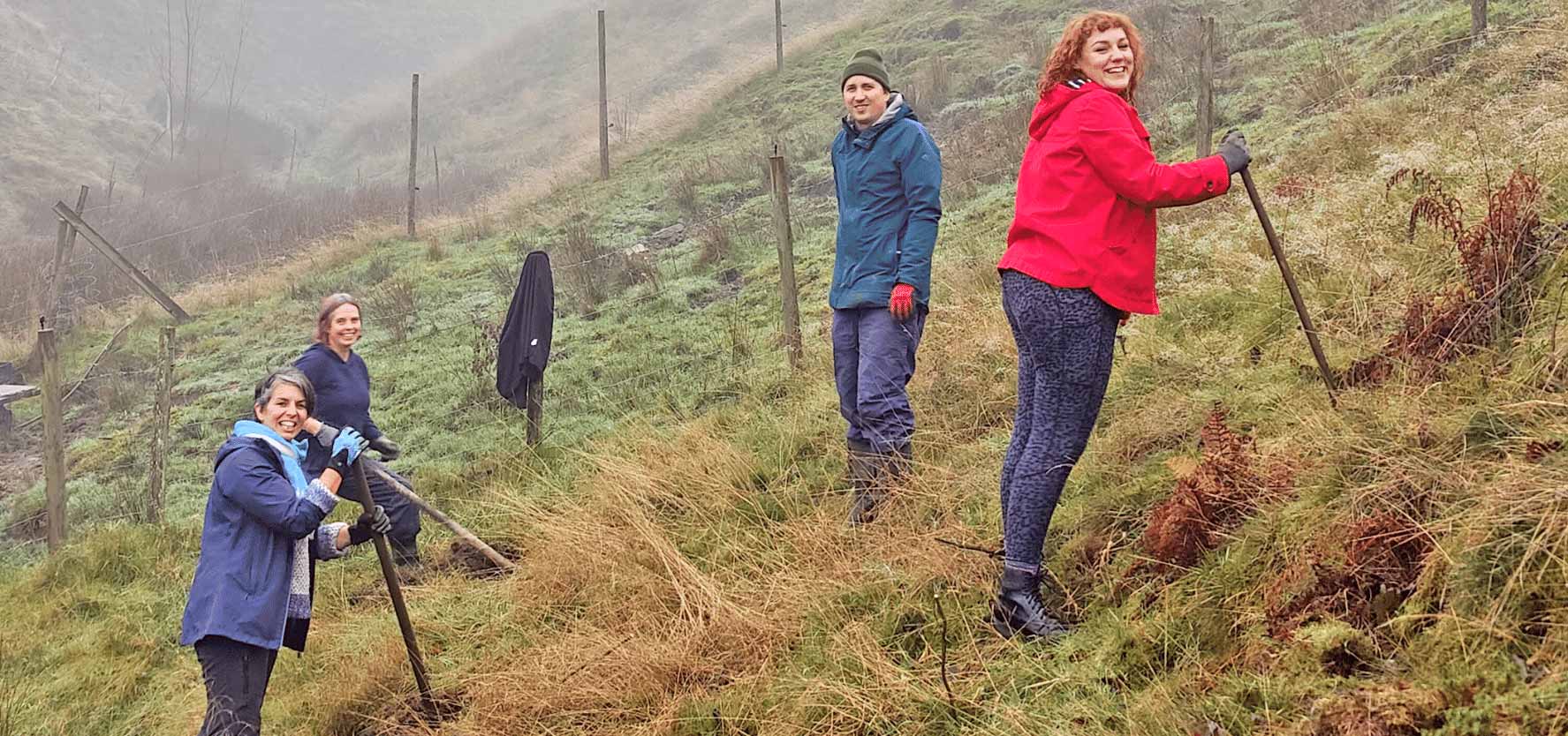 A picture of members of the Conflict and Environment Observatory team. Four members of the team are standing on the hill of a sustainable farm. Picture: CEOBS