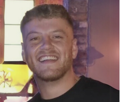 A photo of Kieran smiling at the camera.
