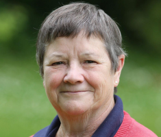 A headshot of Avila Kilmurray who is smiling.